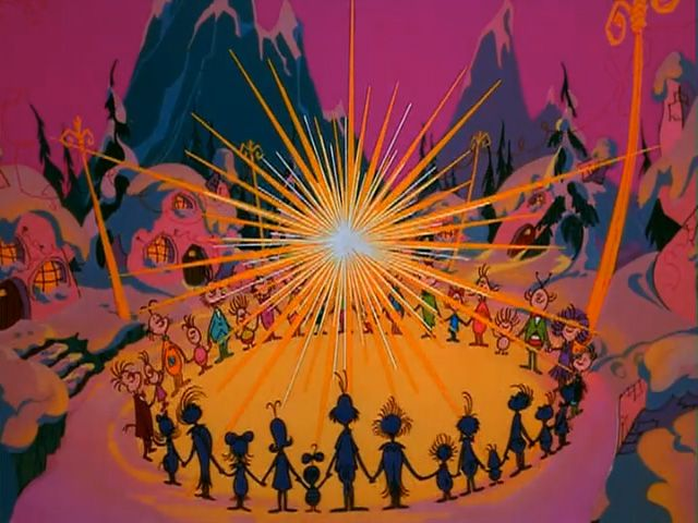 Scene from the cartoon movie "How the Grinch Stole Christmas!" in which the Whos are gathered around the star, singing.